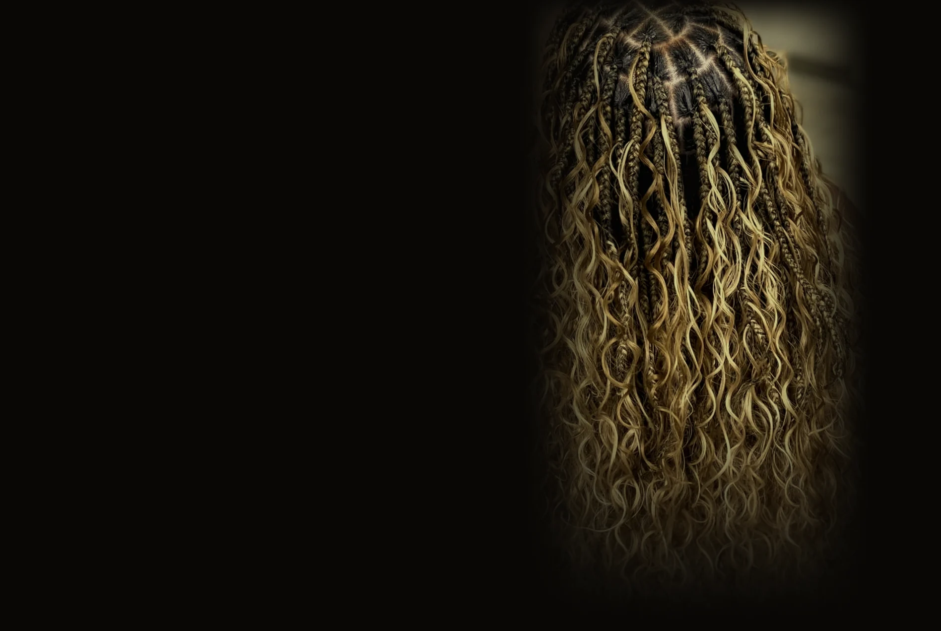 Golden goddess knotless braids by Gigi, seen from behind